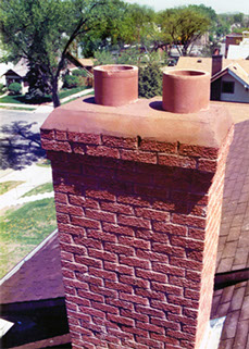 A chimney we rebuilt from the roof of the house back up to its original height. It has a 2 course corbell so water doesn't run down the chimney.