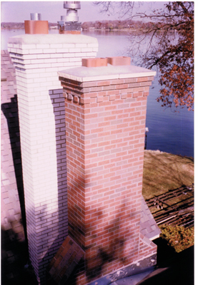 Two chimneys side by side that we rebuilt each of. Each has a corbelled top, meaning the bricks stick out so water doesn't run down the chimney 