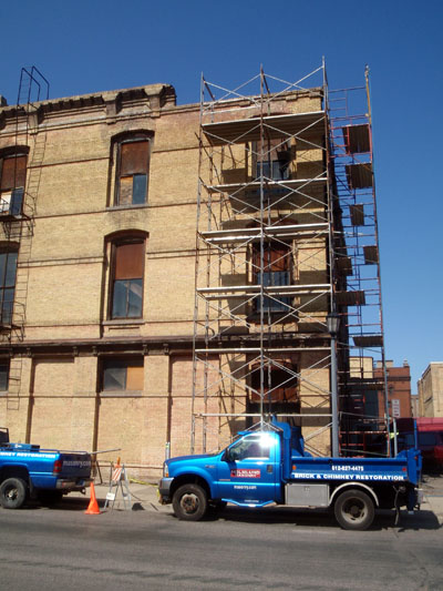 We set up scaffolding downtown to rebuild several arches on a building that had damaged chaska brick.