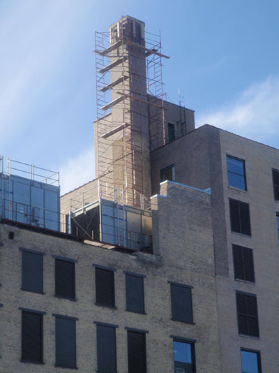 This shows the scaffolding set up to tear down and rebuild the chimney as well as do other repairs.